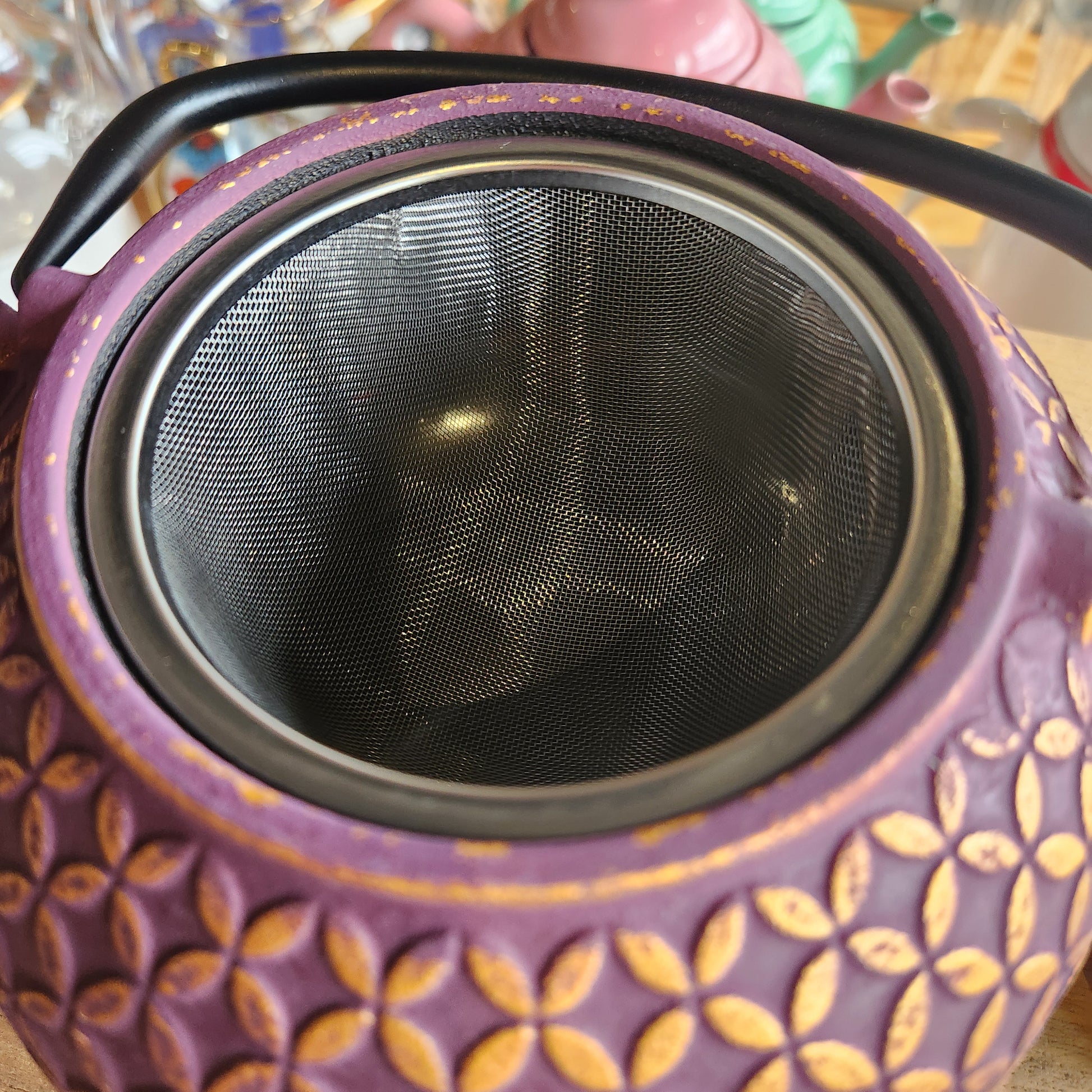 Close up of strainer in purple teapot
